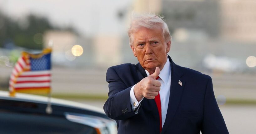 President Donald Trump waves to the media after walking off of Air Force One at Miami International Airport on April 11, 2026, in Miami, Florida.