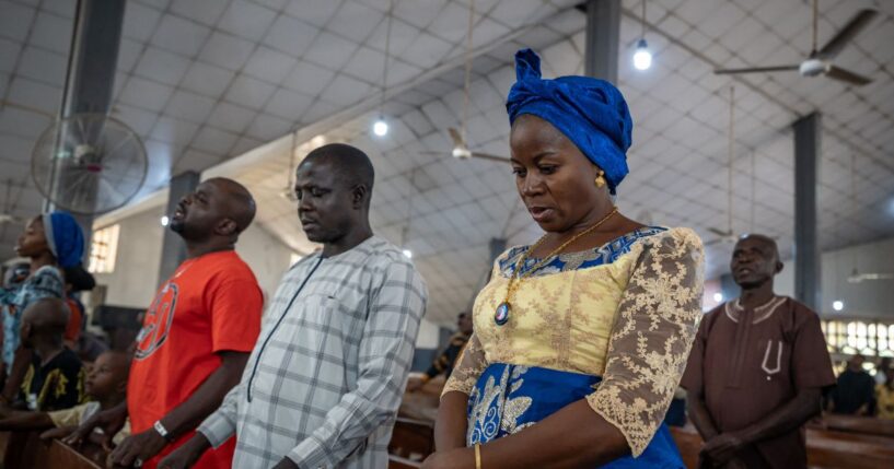 Roman Catholics pray at Saint Michael's Cathedral during the Sunday service in Minna on Nov. 30, 2025.