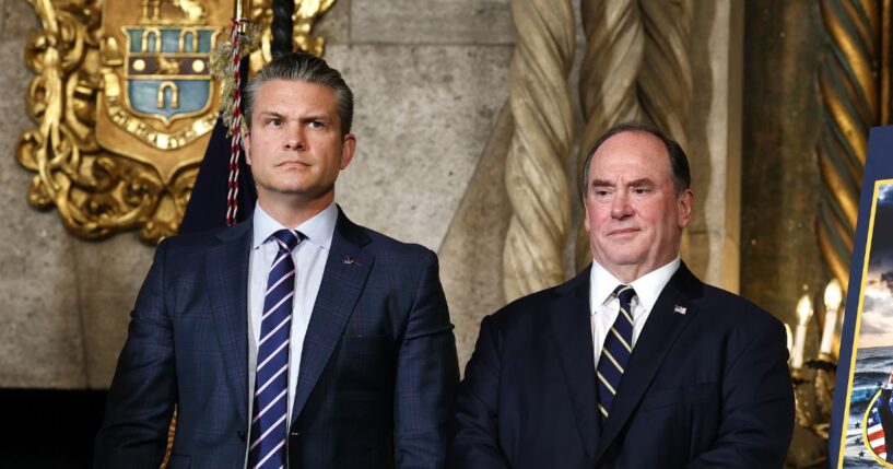 Secretary of War Pete Hegseth and Secretary of the Navy John Phelan stand together as President Donald Trump announced the creation of the “Trump-class” battleship during a statement to the media at Trump’s Mar-a-Lago estate on Dec. 22, 2025, in Palm Beach, Florida.