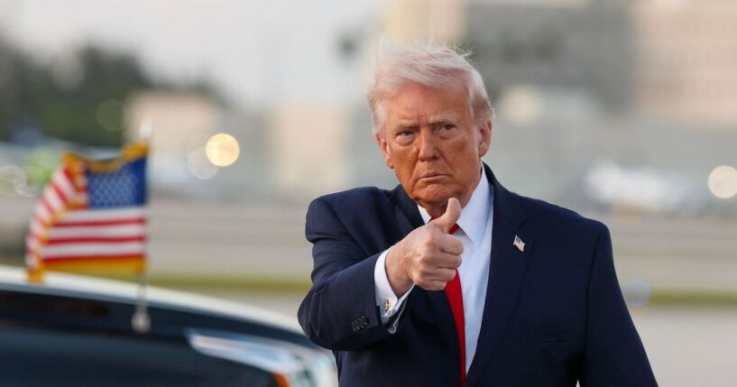 President Donald Trump waves to the media after walking off of Air Force One at Miami International Airport on April 11, 2026, in Miami, Florida.