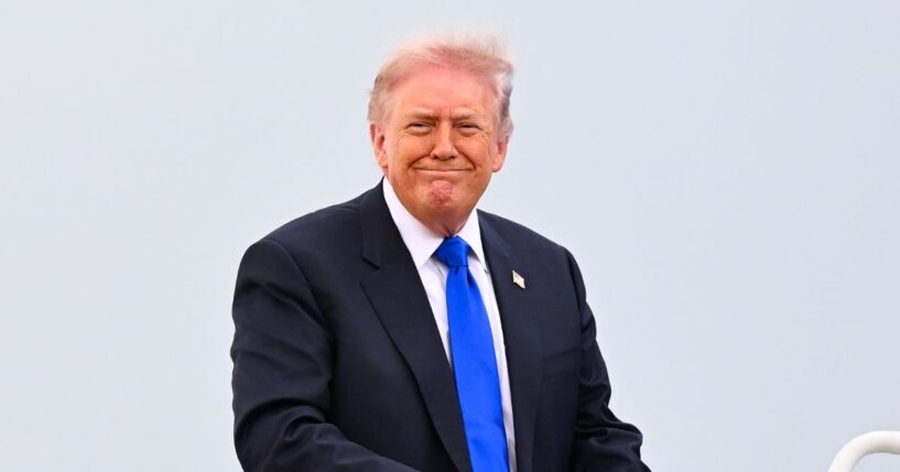 President Donald Trump smiles as he boards Air Force One on April 24, 2026, at Joint Base Andrews, Maryland.