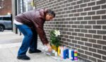 A man lights a candle at the corner where a 7-month-old baby was killed by a stray bullet while sitting in her stroller in Brooklyn Wednesday afternoon.
