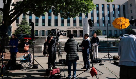 Members of the news media set up outside the E. Barrett Prettyman United States Court House Monday in Washington, D.C., where the alleged White House Correspondents' Dinner gunman, Cole Allen, was expected to be arraigned.