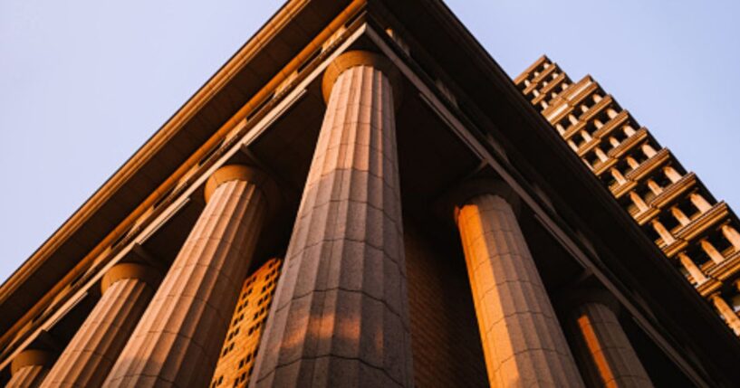 A Neoclassical building stands.