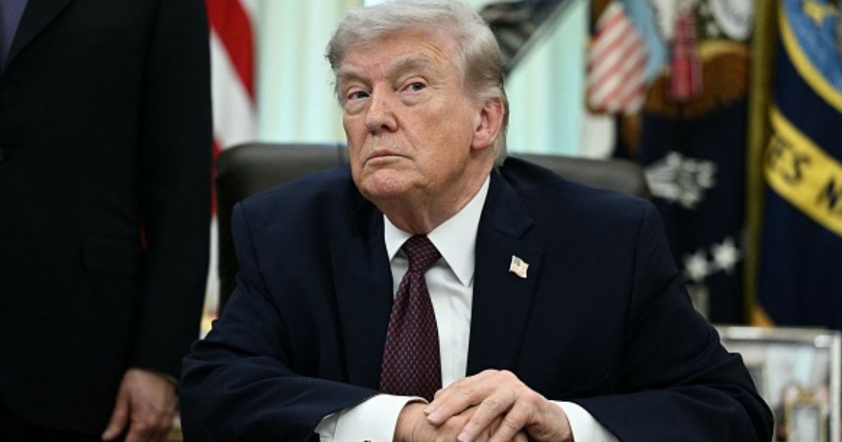 President Donald Trump sits at the Resolute Desk in the Oval Office on March 31, 2026.