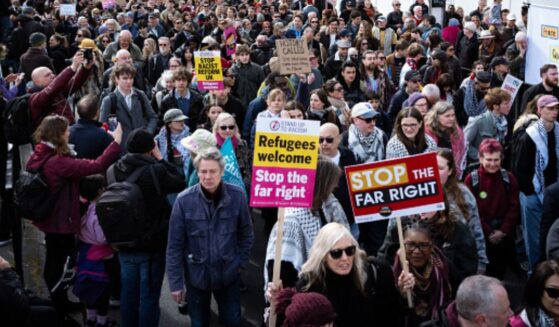 Stand Up To Racism protesters gather in outside on March 28, 2026.