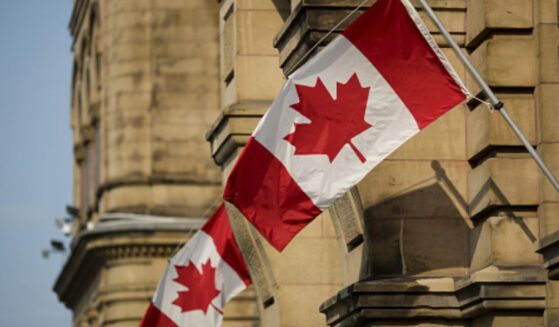 Canadian flags wave at the Capitol Building in Ontario, Canada.