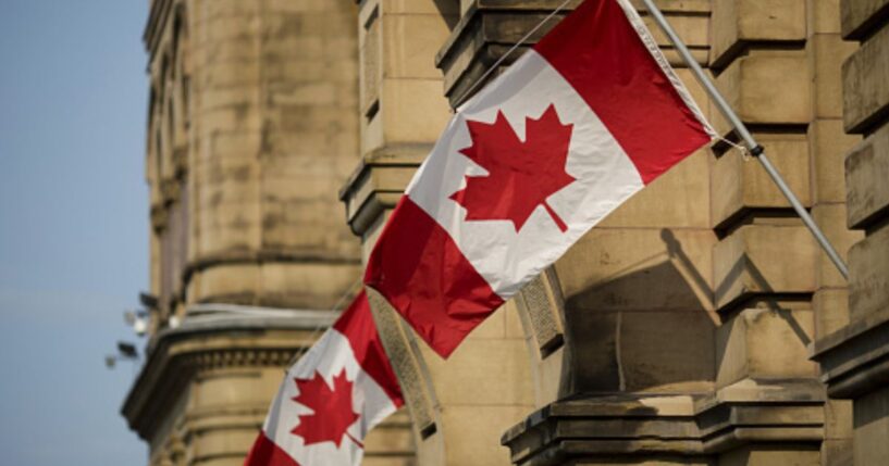 Canadian flags wave at the Capitol Building in Ontario, Canada.