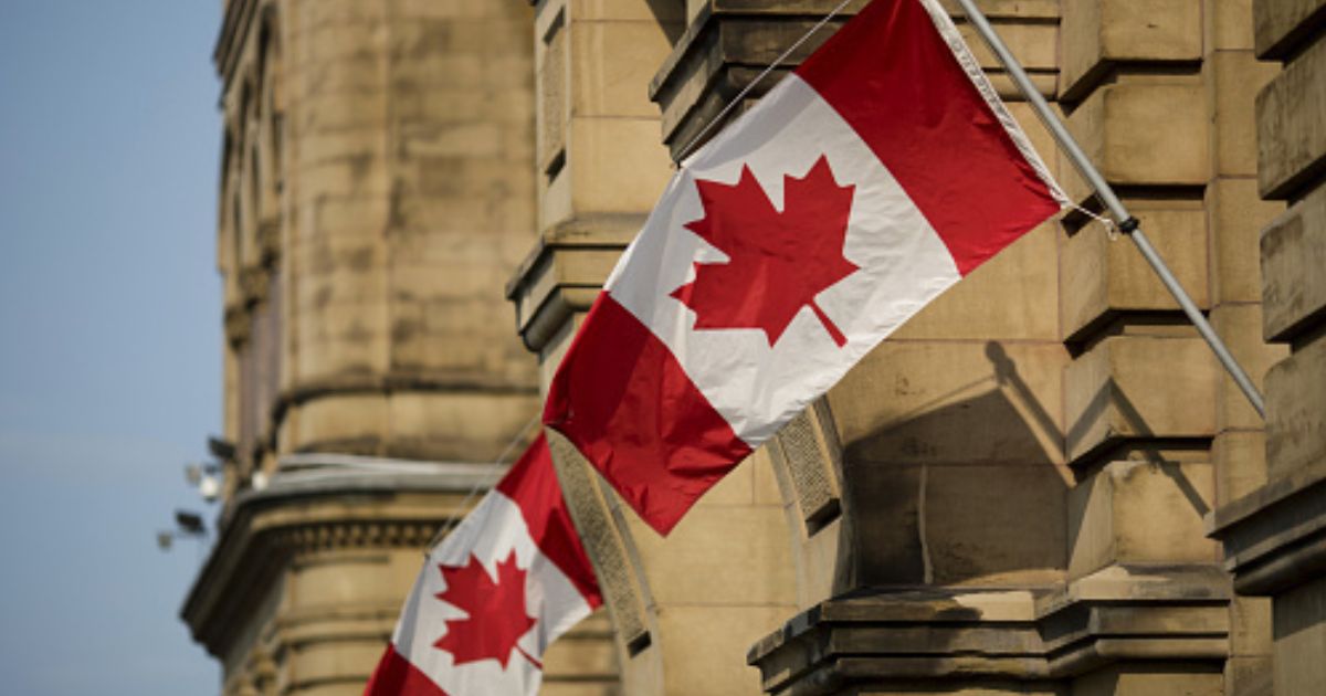 Canadian flags wave at the Capitol Building in Ontario, Canada.