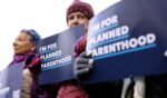 Planned Parenthood protesters stand outside of Moakley Federal Courthouse on November 12, 2025.