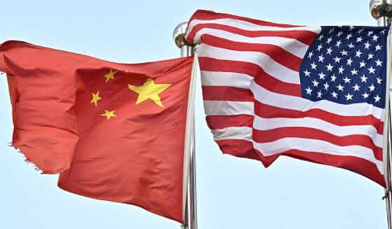 A Chinese flag and American flag wave side by side on April 17, 2025.
