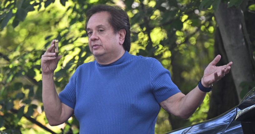 George Conway speaks on the phone outside John Bolton’s Bethesda, Maryland home as raid takes place on August 22, 2025.