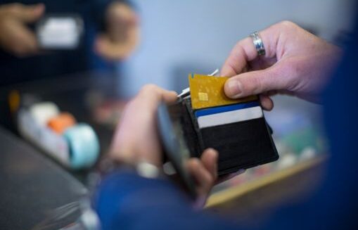 Man pulls card out of wallet.