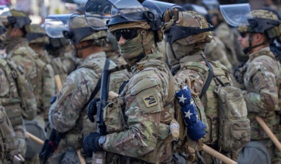 Soldiers stand in Los Angeles as they regulate protests on June 12, 2025.