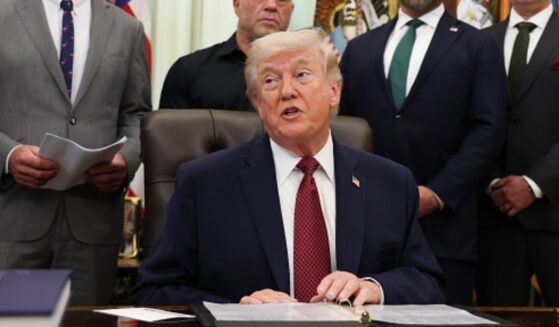 President Trump sits in the Oval Office alongside advisors and administration officials on April 18, 2026.