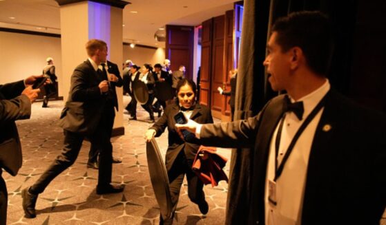 Attendees and security staff scramble in the Washington Hilton on April 25.