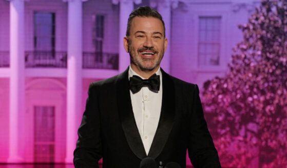 Jimmy Kimmel laughs at podium as he makes jokes to his crowd in a parody of the WHCD on April 23, 2026.
