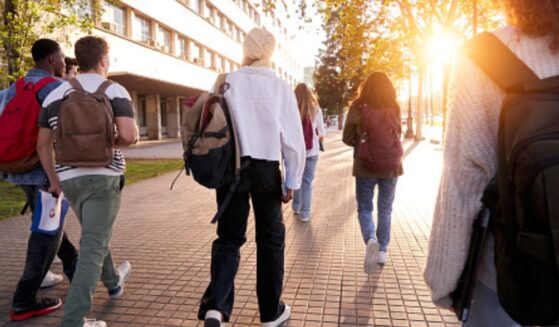 Students walk on a college campus.