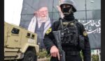 A member of the Iranian security forces stands guard next to a banner honoring Iran's slain supreme leader Ayatollah Ali Khamenei in Tehran on Tuesday.