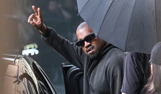 U.S. rapper and producer Kanye West gestures upon arriving at Shanghai Pudong International Airport on July 11.