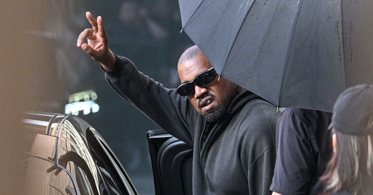 U.S. rapper and producer Kanye West gestures upon arriving at Shanghai Pudong International Airport on July 11.