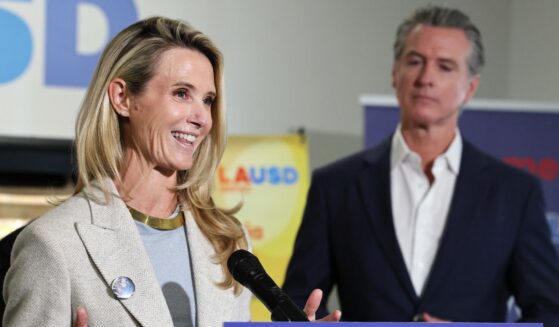 California Governor Gavin Newsom looks on as his wife Jennifer Siebel Newsom speaks at Belvedere Middle School in Los Angeles on Oct. 8, 2025.