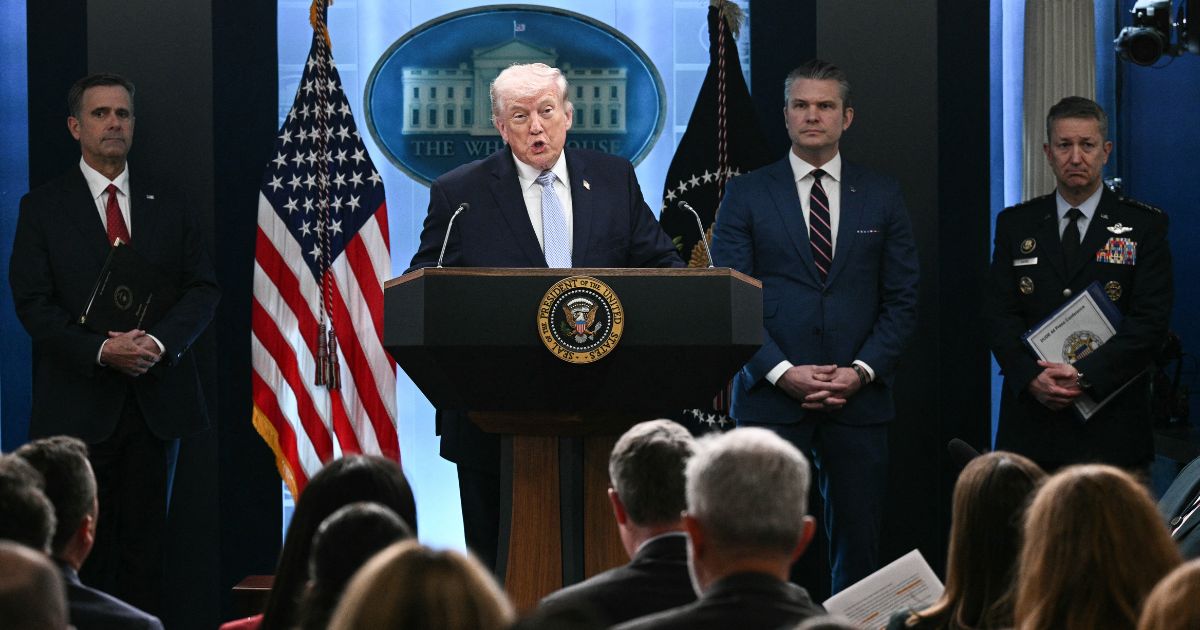 President Donald Trump stands at a podium next to CIA Director John Ratcliffe, US Secretary of Defense Pete Hegseth, and Chairman of the Joint Chiefs of Staff General Dan Caine as he speaks about the Iran conflict in the James S. Brady Press Briefing Room of the White House in Washington, DC on April 6, 2026.