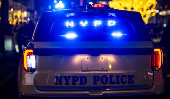 A New York City Police Department night patrol car stops in traffic.