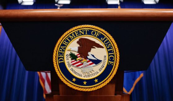 The seal of the Department of Justice sits on a podium in the Department of Justice headquarters in Washington, DC on April 7, 2026.