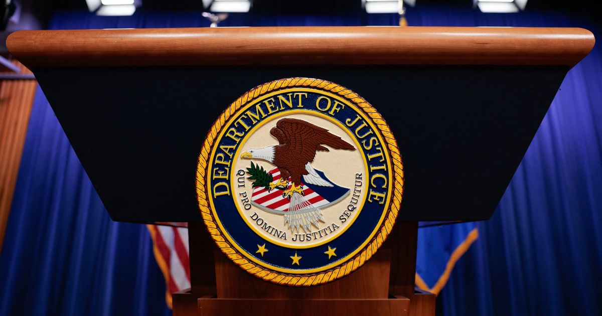 The seal of the Department of Justice sits on a podium in the Department of Justice headquarters in Washington, DC on April 7, 2026.