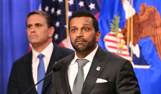 FBI Director Kash Patel stands in front of Attorney General Todd Blanche as he explains the indictment of the Southern Poverty Law Center on April 21, 2026 in at the Department of Justice in Washington, DC.