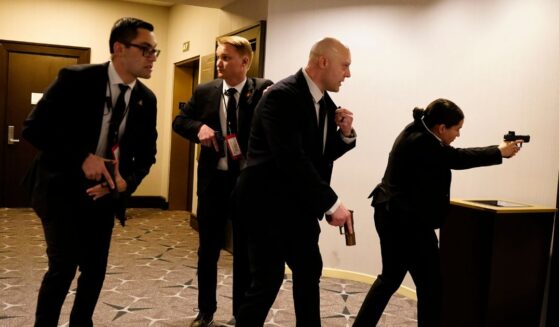 Federal agents with their guns drawn react to an incident that occurred at the annual White House Correspondents Association Dinner on April 25, 2026 in Washington, DC.