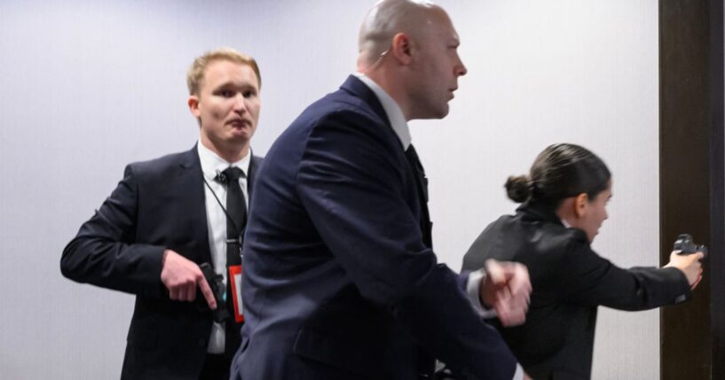 Agents draw their firearms after a shooting took place at the White House Correspondents' dinner at the Washington Hilton in Washington, DC on April 25, 2026.