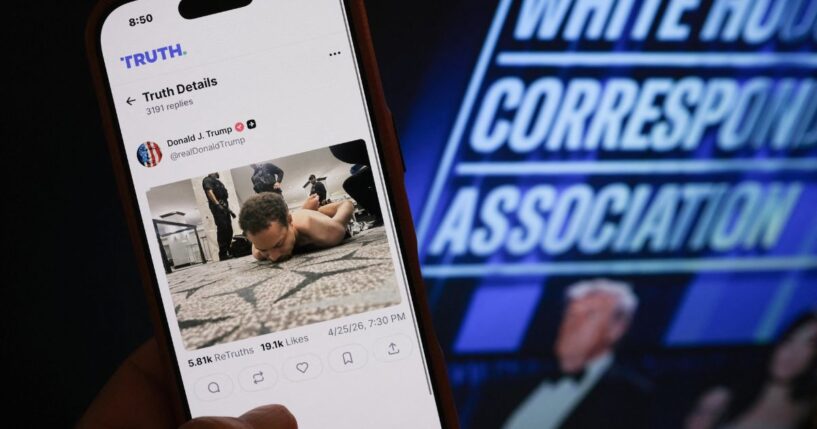Someone holds a phone with a picture of a post published by President Donald Trump on Truth Social showing the alleged shooter accused of opening fire at the White House Correspondents' dinner in Washington, DC on April 25, 2026.