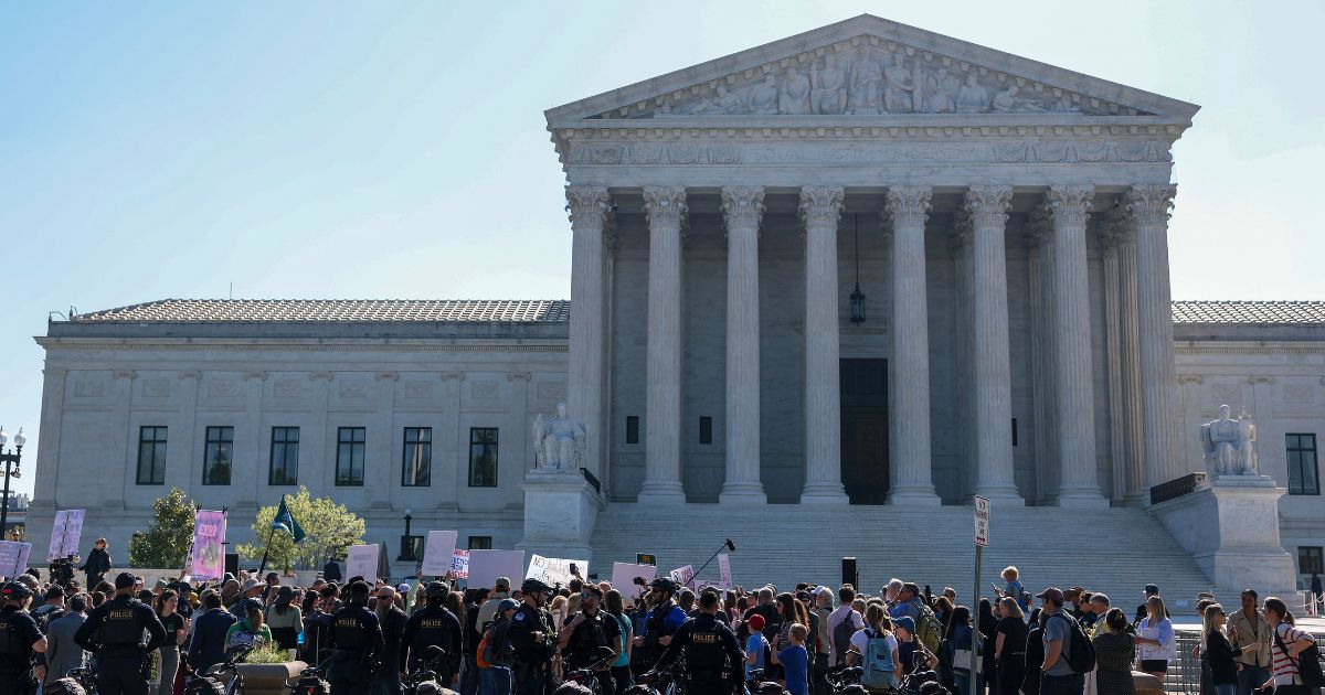 Protesters gather outside the Supreme Court building on April 27, 2026.