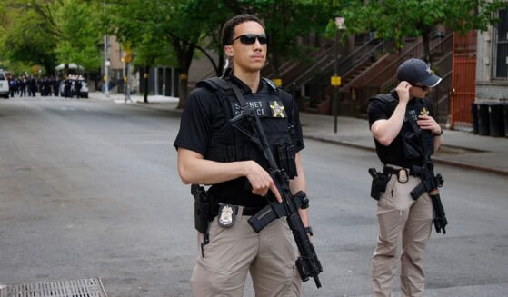 Armed Secret Service agents stand near non-profit Harlem Grown before a visit by Britain's King Charles III in New York Wednesday. Agents detained a man who bypassed a security barrier Tuesday near the White House while the king was in Washington, D.C.