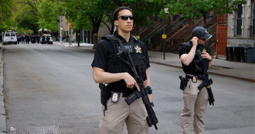 Armed Secret Service agents stand near non-profit Harlem Grown before a visit by Britain's King Charles III in New York Wednesday. Agents detained a man who bypassed a security barrier Tuesday near the White House while the king was in Washington, D.C.
