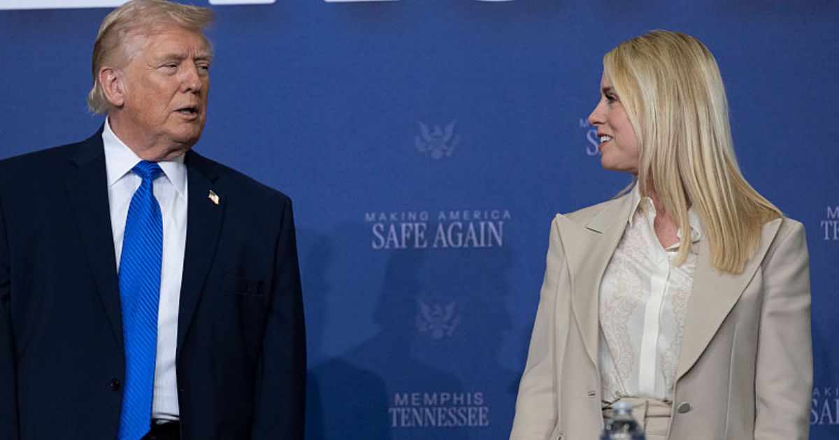 President Donald Trump interacts with then-Attorney General Pam Bondi March 23 at a "Making America Safe Again" meeting at the Memphis International Airport in Memphis, Tennessee.