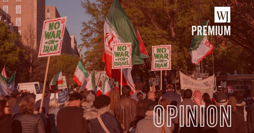 Protesters in opposition to the war with Iran carry signs and Iranian flags as they gather April 7 outside of Lafayette Park across from the White House in Washington, D.C.