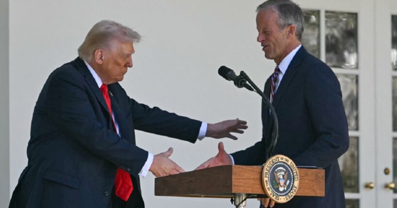 President Donald Trump shakes Senate Majority Leader John Thune's hand during an October event at outside the White House.