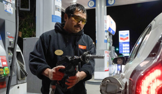 A man using a gas pump.