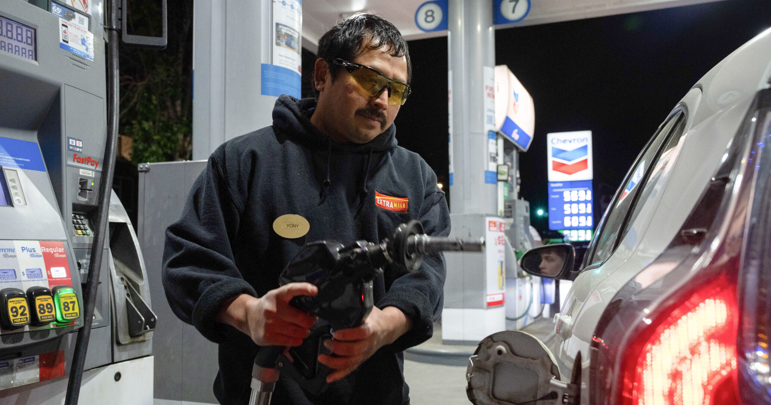 A man using a gas pump.