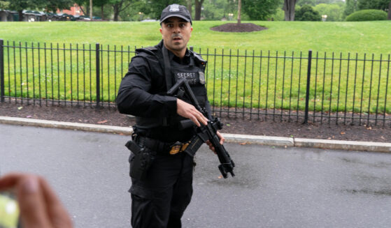 A Secret Service officer prevents journalists from leaving the White House on May 23, 2026.