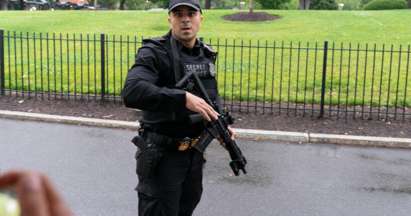 A Secret Service officer prevents journalists from leaving the White House on May 23, 2026.