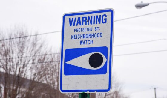 A blue and white neighborhood watch sign.