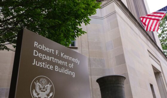 A sign is displayed outside of the Robert F. Kennedy U.S. Department of Justice building in June 2025 in Washington, D.C.