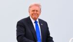 President Donald Trump smiles as he boards Air Force One on April 24, 2026 at Joint Base Andrews, Maryland.