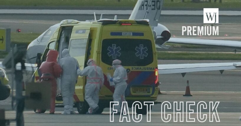 People in hazmat suits escorting an individual believed to be infected with hantavirus into a medical vehicle in Spain's Canary Islands on May 6, 2026.