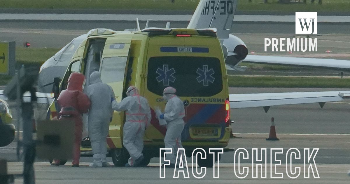 People in hazmat suits escorting an individual believed to be infected with hantavirus into a medical vehicle in Spain's Canary Islands on May 6, 2026.