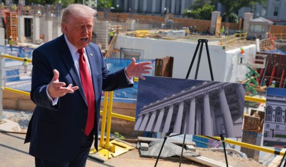 President Donald Trump speaks to the media Tuesday alongside posters of his proposed White House ballroom amid construction at the White House in Washington, D.C.